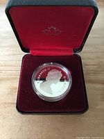 Coin obverse showing Queen Elizabeth II within encapsulation in red case