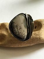 Front view showing dendritic agate cabochon and feather bezel