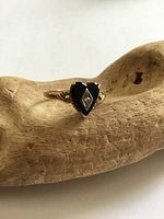 Front view of heart onyx ring with diamond center