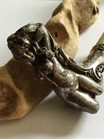 Front view of cane handle showing nude woman relief and curvature