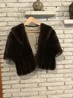 Front view of brown fur stole on hanger