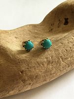 Front view of both turquoise stud earrings in rose gold crown settings