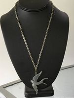 Necklace displayed on stand showing full pendant and chain