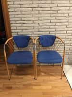 Pair of blue fabric and chrome spindle chairs front view