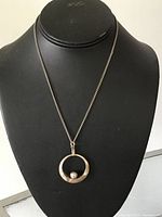 Full view of pendant necklace on display bust