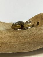 Front view of sterling silver ring showing brass spinner and garnet