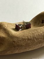 Front view of pair showing red stones in silver settings