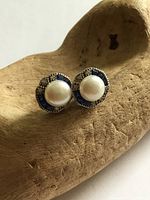 Front view of both earrings showing pearls and gemstone halos