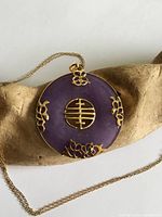 Front view of purple jade pendant on chain