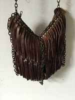 Front view showing leather strips and chain sides