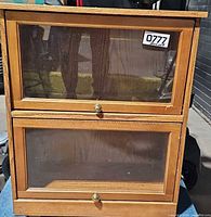 Front view showing two glass doors and brass knobs