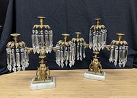 Pair of gilt brass crystal candelabra on marble bases, full view