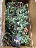 Garland in original box showing foliage, berries, pine cones and Frontgate tag
