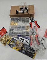 Overview showing grommet assortment box, pliers, punch kit, C-clamp box, loose grommet pack