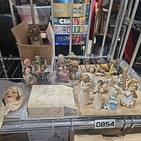 Shelf with assorted figurines, Avon box, wall plaque, ducks and candle holders