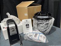 Pressure cooker, can opener, box, accessories overview