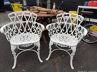 Front view of both white cast aluminum chairs