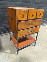 Front view of wood drawer cabinet on metal stand