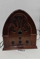 Front view of Welbilt wooden cathedral radio with power cord