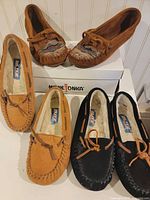 Three pairs moccasins on display