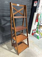 Front view of wooden 4-tier shelf showing overall structure