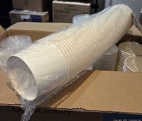 Sleeve of nested white paper soup cups inside carton