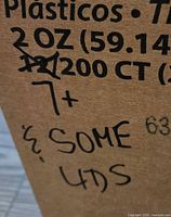 Box labeled Sysco Reliance Portion Cups 2 oz with handwritten note '7+ & some lids'