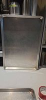 Single cookie sheet upright showing size and rim detail