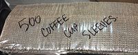 Shrink-wrapped bundle marked "500 coffee cup sleeves"