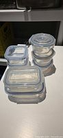 Stacked square and round glass containers with lids