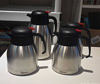 Four Omcan stainless steel insulated servers front view