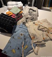 Group of aprons, towels and dishcloths on tabletop