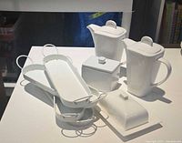 porcelain serveware and metal trays grouped