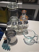 Group view: glass jars, flour sifter, measuring cup, measuring spoons