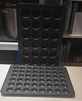 48-cup mini muffin pan standing upright beside 24-cup pan