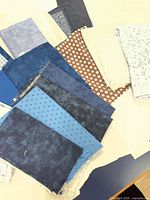 stacked blue, cream and brown cotton fabric pieces showing patterns
