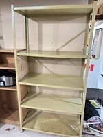 Front view of entire steel shelving unit showing five shelves and frame