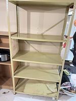 Front view of steel shelving unit showing all five shelves