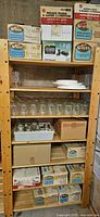 Shelving unit with boxed Kerr jars, loose jars and bin of metal bands