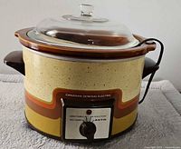 Front view of Canadian General Electric crock pot showing dial, branding, glass lid and power cord
