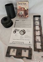 Lot overview showing Nikon adapter, Pana-Vue viewer box, film holders and manual
