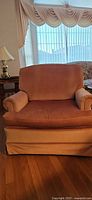 Front view of dusty rose velveteen club chair