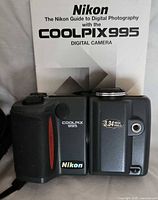 Front view of Nikon Coolpix 995 camera with manual
