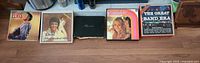 Five record items laid out: Elvis LP, Elvis box, binder, Reader’s Digest set, Great Band Era box