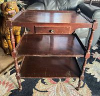 Full front view showing three shelves, drawer, legs