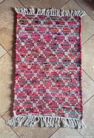 Full view of rug showing size, pattern and fringe