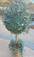 Full view of faux ivy topiary tree in pot