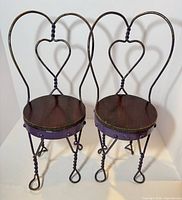 Both wrought iron doll chairs front view