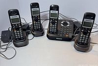 Full set with four handsets in cradles, base station and adapters