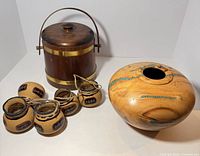 Group shot of turquoise inlaid vase, wood firkin, and four carved gourd vessels